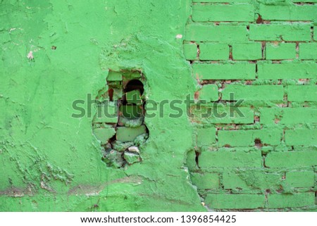 Old green cement wall with brick in industrial building, great for design and texture background.
