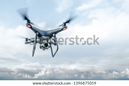 Drone in the sky. Unmanned aerial vehicle flying in the air. Royalty-Free Stock Photo #1396875059