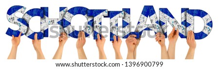 people arms hands holding up wooden letter lettering forming german word Schottland (english translation Scotland) scottish flag colors tourism travel elections concept isolated white background