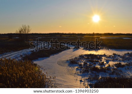 Landscape of sunset and or sunrise over fields on farms in the woods on land 