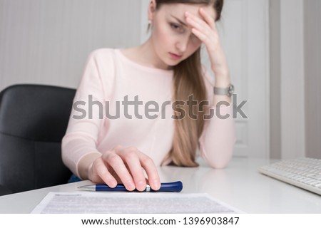 Sad businesswoman does not want to sign a contract, documents on his desk, close up