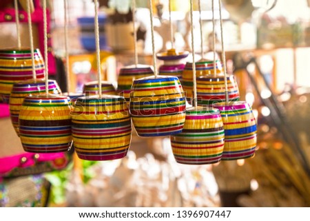 a picture of a group of a multicolor mexican balero, a typical mexican toy and a handcraft, taken in a marketplace, 