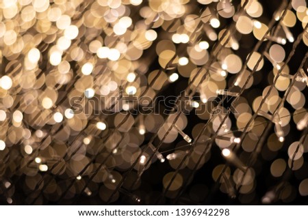 A small light bulb at night has a bokeh background.