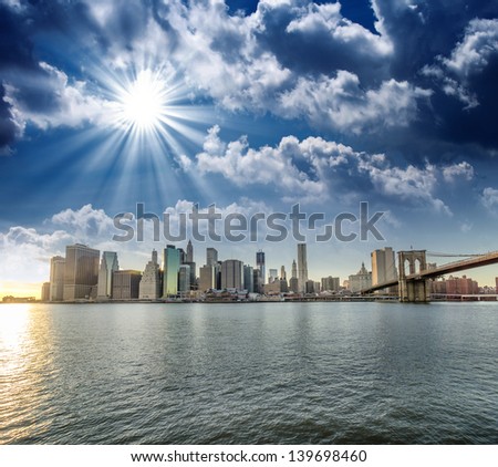Amazing New York Cityscape - Skyscrapers and Brooklyn Bridge at sunset - USA
