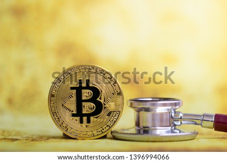Gold bitcoin with stethoscope check up on white background Health care. health care industry could benefit from varied applications of blockchain technology. Blockchain for Health Data.