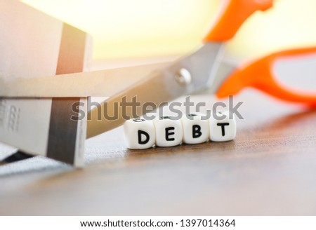 Cutting debt / Cut credit card with scissors for stop to pay money protect cost financial crisis and problems risk business management loan interest