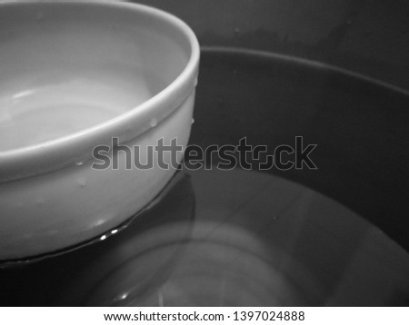water dipper in container close up black and white