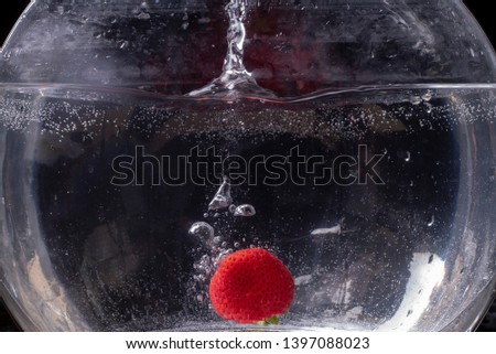 Refreshing strawberry dropped into sparkling water. 