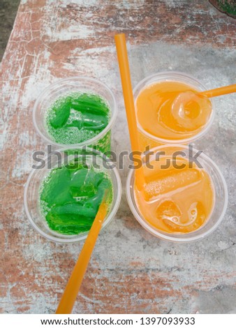 Green water and orange juice are appetizing.