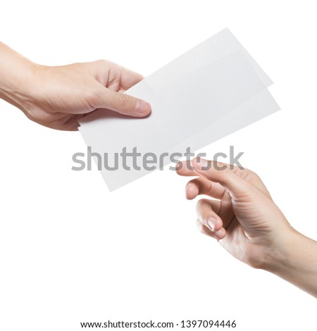 Hand giving two blank sheets of paper (tickets, flyers, invitations, coupons, money, etc.), isolated on white background