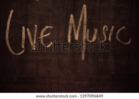 Live music sign on blackboard at restaurant