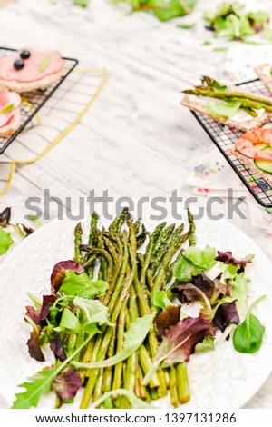 Summer snack sandwiches and asparagus, on a white wooden table. Top view. Free space for text
