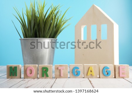 Mortgage Alphabet on Wooden cube. House and property mortgage concept