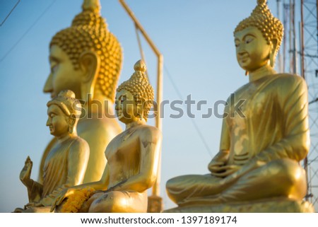 Closeup view of Buddha golden statues on blue sky background on top of Tiger Cave Mountain Temple. Krabi, Thailand