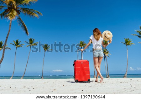 Pretty woman walking along the beach red  sand ocean journey sun