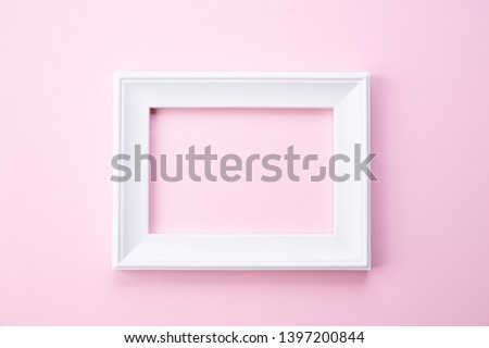 Happy Mothers day concept. Top view of white picture frame on pink pastel background. Flat lay.