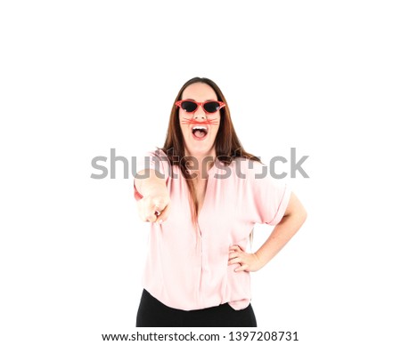 Happy young woman doing a thumb up gesture with her hand while wearing red sunglasses against a white background