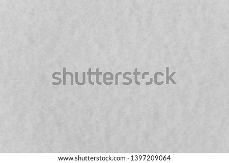 Abstract grey stained paper texture background or backdrop. Empty old gray paperboard or grainy cardboard for decorative design element. Simple monochrome surface for journal template presentation.