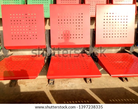 view of stadium with empty seat. Red iron seat in soccer stadium when holiday. Landscape of free arena seating.  