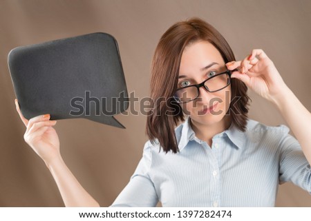 Woman in glasses holding blank black slate with copy space. Short message, question and announcement theme.