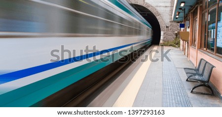 White high speed train runs on rail tracks . Train in motion 