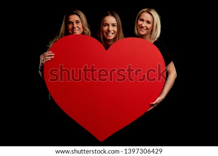 Group of friends partying and holding hearts
