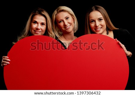 Group of friends partying and holding hearts