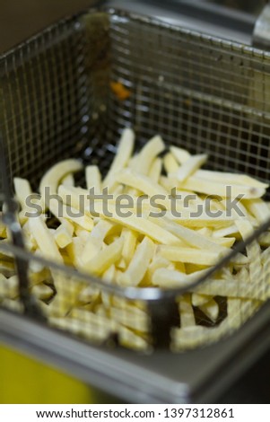 french fries in hot oil, raw potato