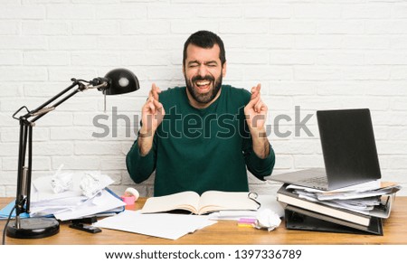 Student man with fingers crossing