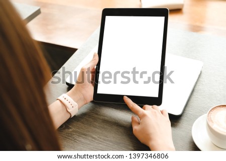 mockup image computer,taplet blank screen for hand typing text,using laptop contact business searching information in workplace on desk at office.design creative work space on wooden desk 