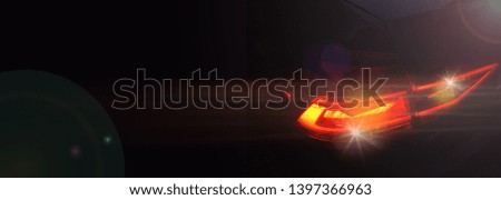 Headlight of a modern car in dense fog against dark background. Exterior details and beauty of technical innovations. Negative space to insert your text or image. Flyer for ad.
