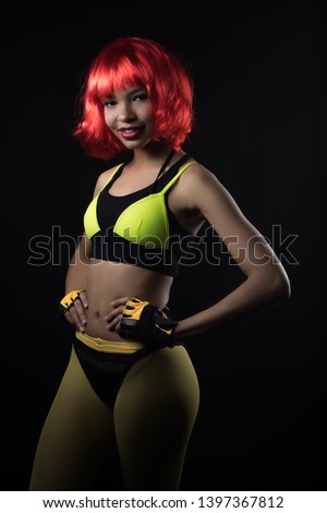 African-American woman in a sports image and a red wig.