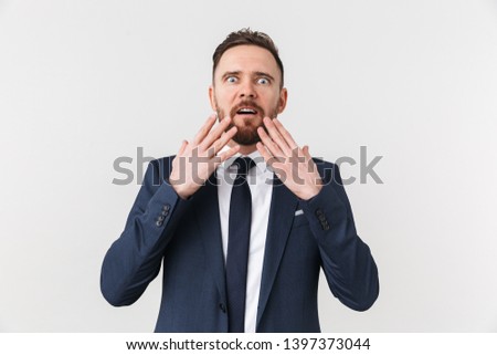 Image of a shocked emotional young businessman posing isolated over white wall background.