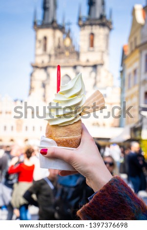 Traditional Tasty Baked Trdelnik with Ice Cream in Czech Republic, Tyn Church on the Background