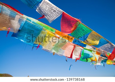 buddhist prayer flags against blue sky in Tibet Royalty-Free Stock Photo #139738168