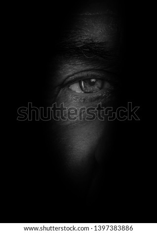 eyes hidden in shadow  spying concept Royalty-Free Stock Photo #1397383886