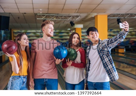 Friends taking selfie in bowling club