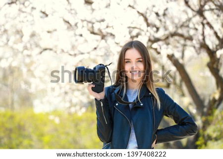 Beautiful female photographer working outdoors