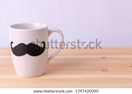 Happy fathers day concept. Coffee cup with black paper mustache on wooden background. Love Dad my hero.