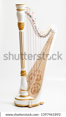 Harp Stringed Musical Instrument Isolated, wood carving and gold Royalty-Free Stock Photo #1397461892