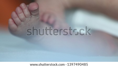 Close-up of baby feet, newborn toddler in first days of life