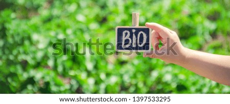 bio farm sign in the hands of a child. selective focus. nature.