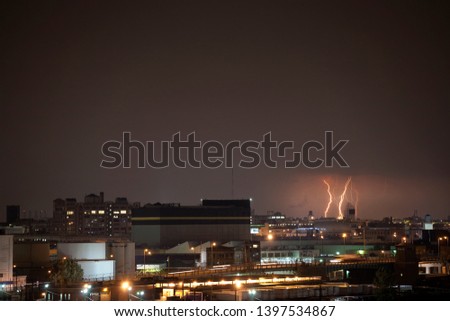 a lightning storm hits new york city on a cloudy beautiful night.