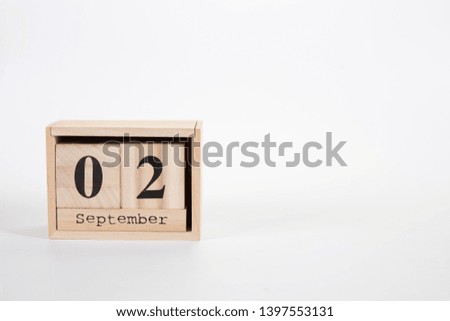 Wooden calendar September 02 on a white background close up
