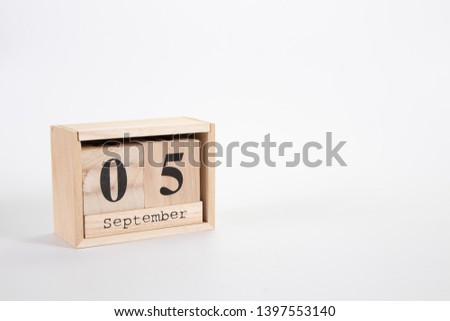Wooden calendar September 05 on a white background close up