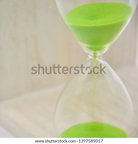Hourglass, with green sand, arranged in different ways