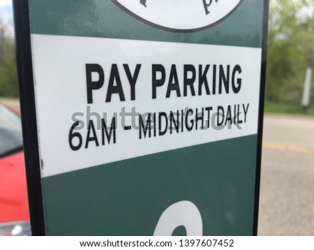 Pay Parking sign 6AM to midnight daily hours six morning public driving transport pavement lot terminal