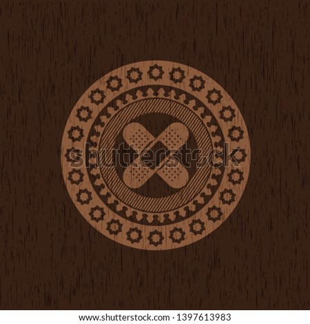 crossed bandage plaster icon inside realistic wooden emblem