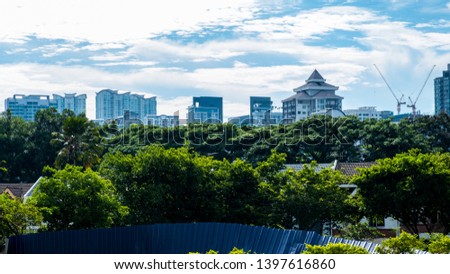 Cityscape with green trees and park in foreground