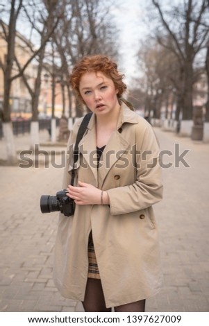 girl photographer. redhead beautiful woman